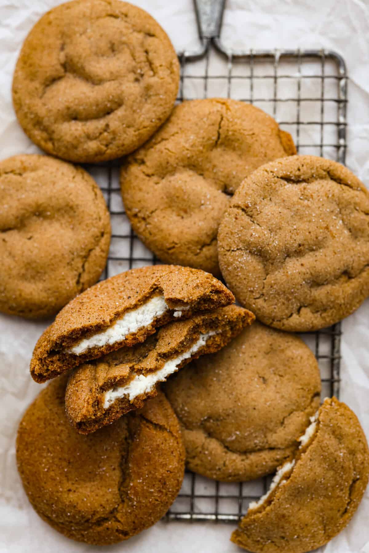 A fun twist on a holiday favorite! These cheesecake stuffed gingerbread cookies are soft and spiced to perfection, filled with a rich and creamy filling. Each bite is a dream! Cheesecake stuffed gingerbread cookies on a wire rack.