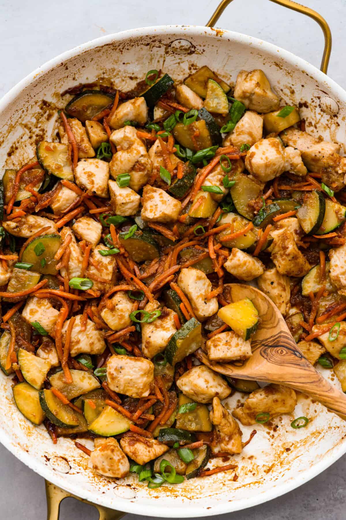 Seared to golden perfection in a savory sauce, you're going to love enjoying this hibachi chicken from the comfort of your kitchen! Top-down view of hibachi chicken and cooked vegetables in a skillet.