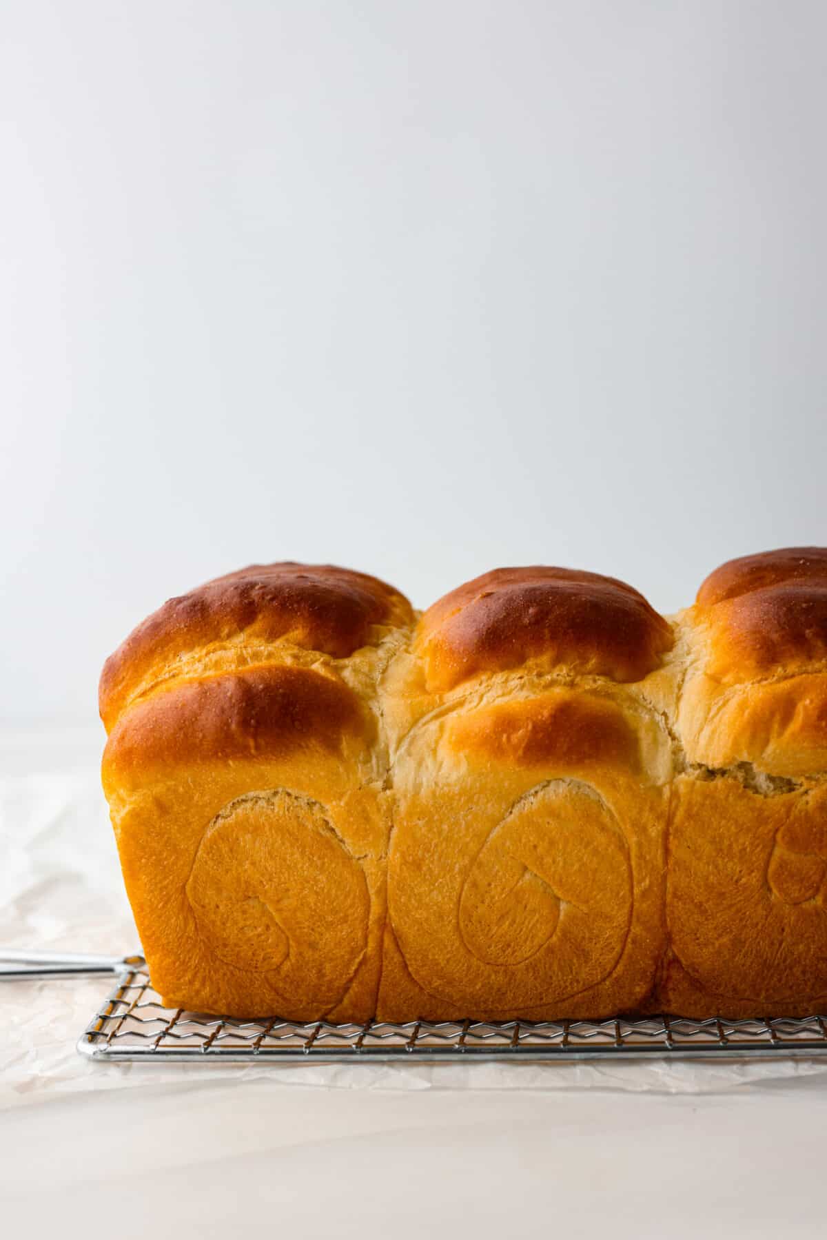 The softest, fluffiest, most delicious bread you'll ever have! Japanese milk bread is a game-changer and will have you in love at first bite. A loaf of Japanese milk bread.