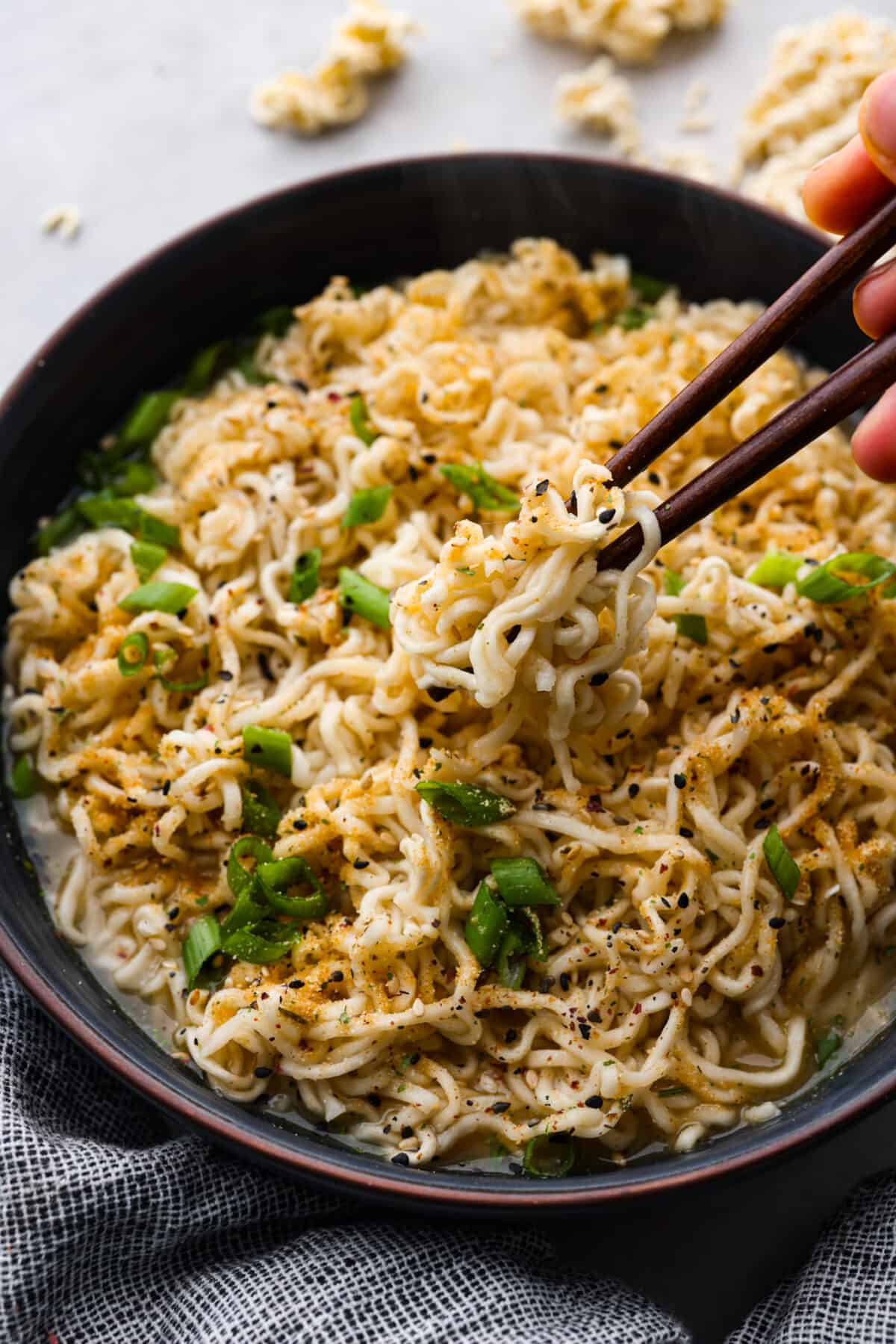 Ditch the flavor packet and elevate your bowl with this homemade ramen seasoning! Packed with savory spices and a punch of garlic, it's the secret ingredient to restaurant-worthy broth in just minutes. Closeup of cooked ramen noodles.