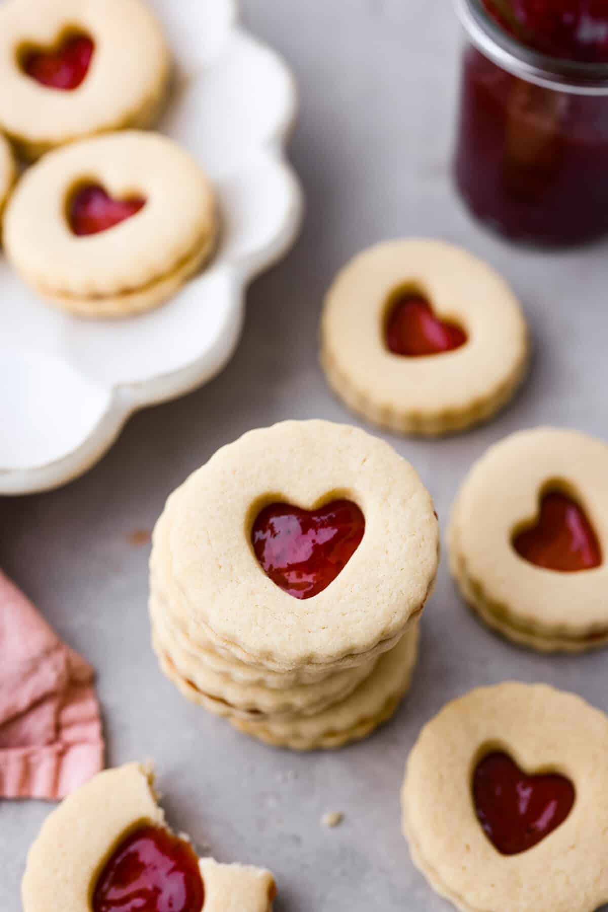 Adorable Jammie Dodgers feature tart strawberry jam sandwiched betweenย buttery shortbread cookies for a gorgeous treat that will be the star of any dessert spread! A stack of jam-filled shortbread cookies.
