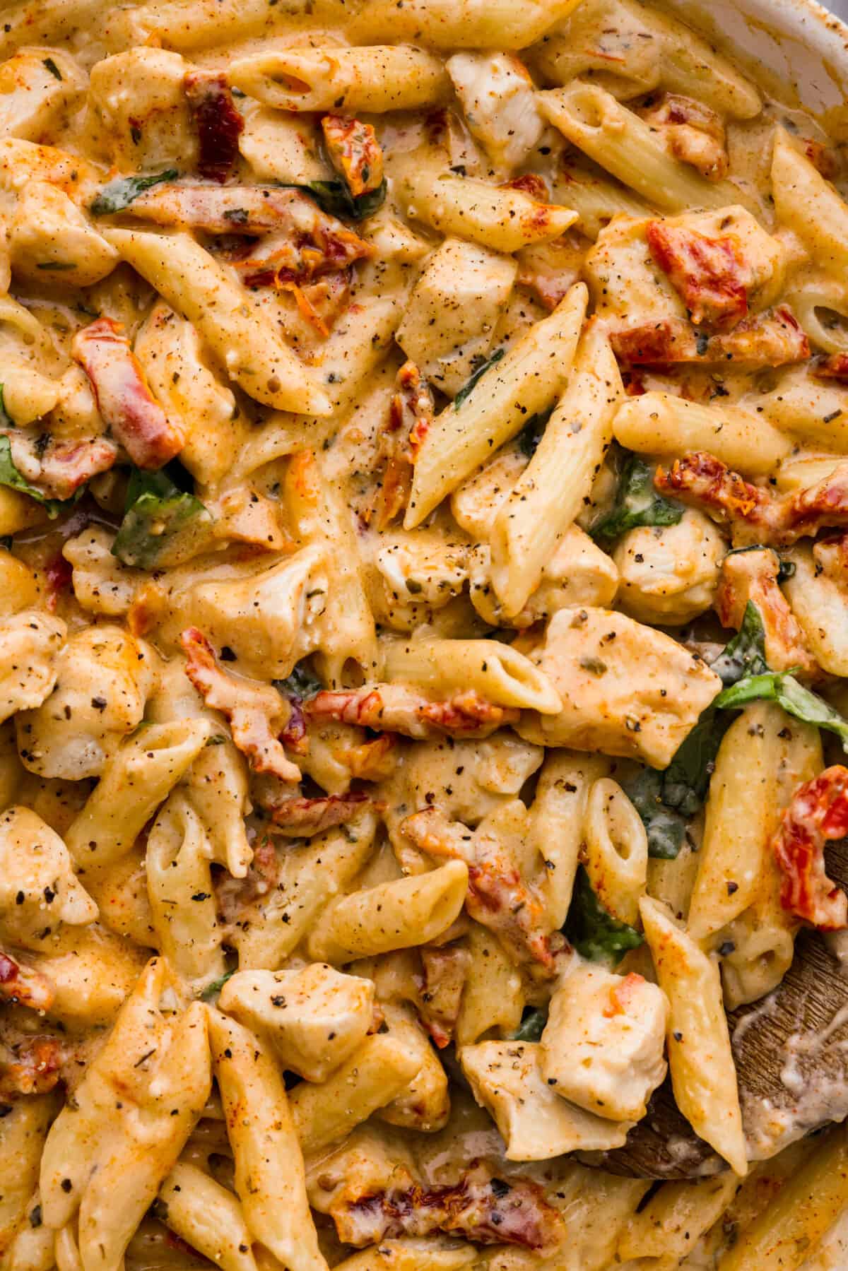 Reader-favorite ‘Marry Me Chicken’ made even better with tender penne pasta! The noodles hold the cheesy, sun-dried tomato sauce inside for a burst of flavor in each bite! It’s sure to win over anyone that tries it. Closeup of the sun-dried tomato pasta.