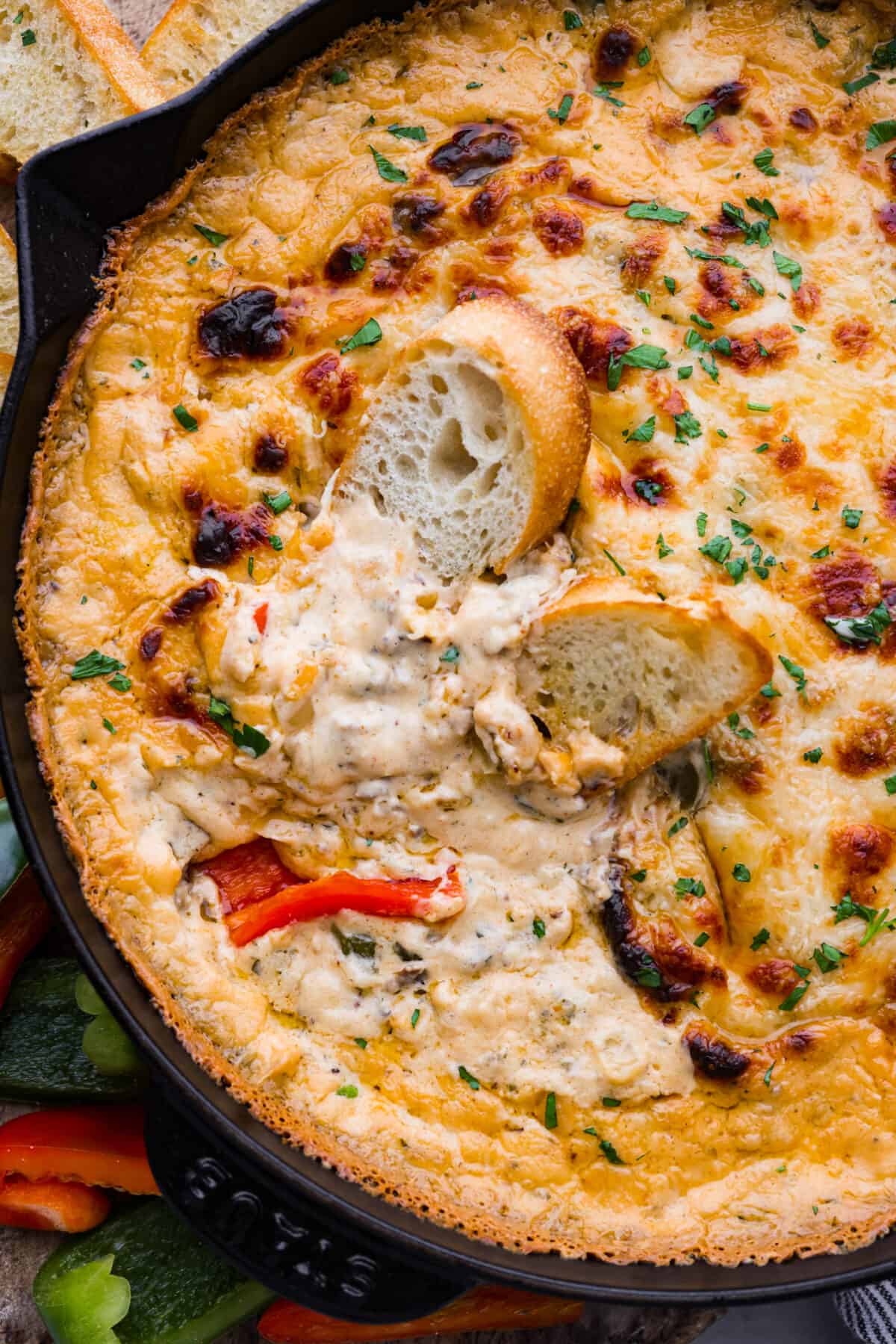 Craving a Philly cheesesteak but want something dippable and shareable? Skip the sandwich and whip up this Philly Cheesesteak Dip instead. It's bursting with tender roast beef and savory spices, all in a creamy, cheesy base. A must-make appetizer for any occasion! Closeup of Philly cheesesteak dip.
