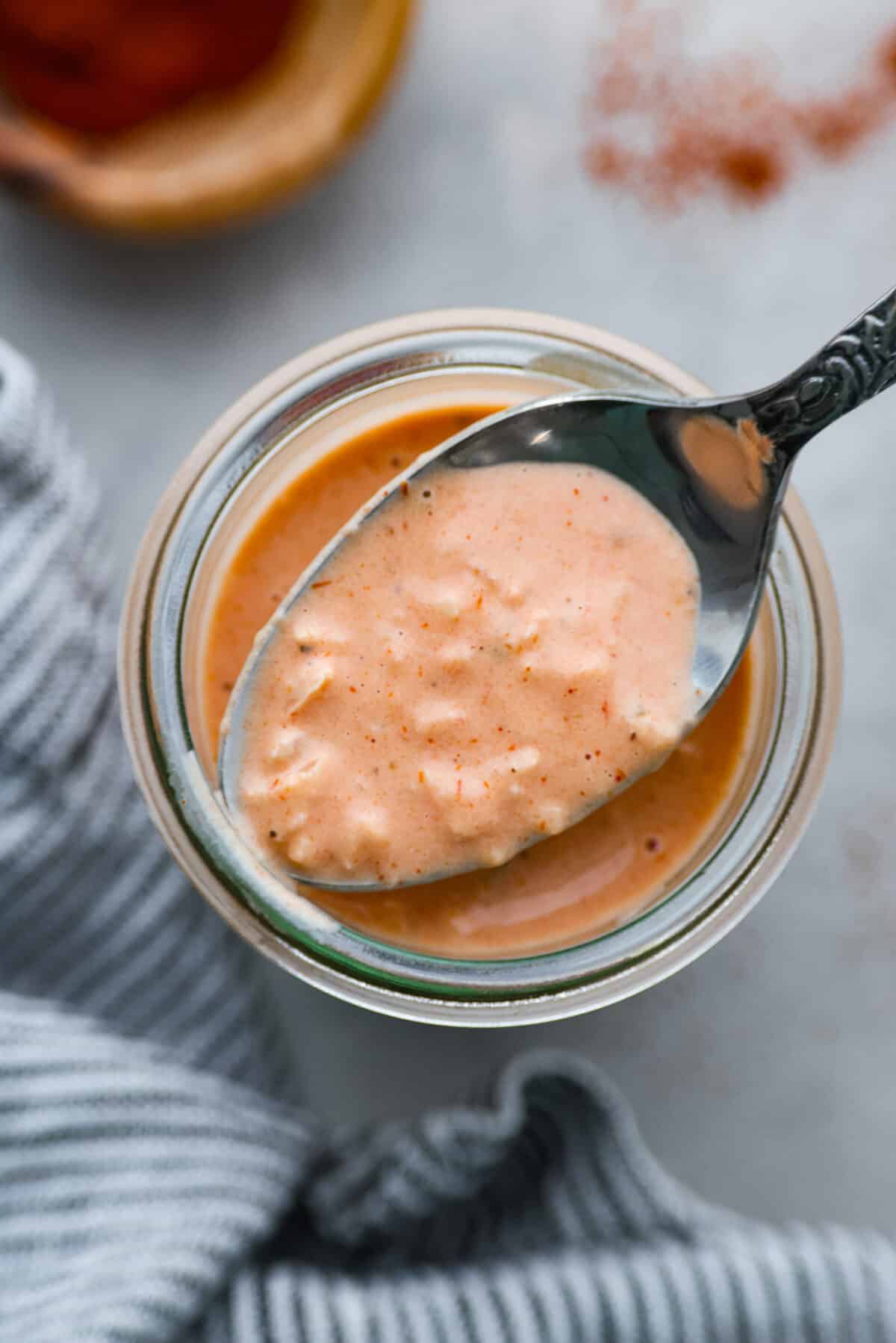 Homemade Russian dressing is a creamy and flavorful condiment perfect for sandwiches, burgers, and even as a dip. It's easy to make with simple ingredients and has the perfect balance of sweet, tangy, and spicy flavors. Top-down view of a jar of Russian dressing.