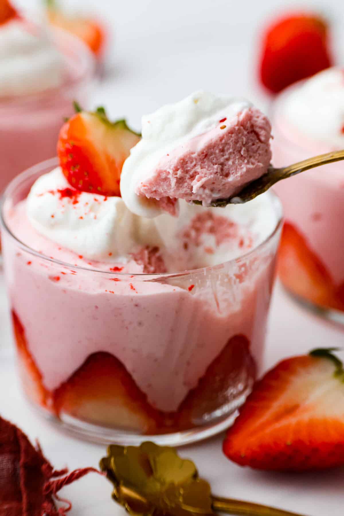 Deliciously sweet and creamy, this Strawberry Mousse is a dessert that looks impressive, yet is so easy to make. It tastes amazing, is bursting with fruity flavor, and would be the perfect treat for any occasion! Taking a bite of strawberry mousse.