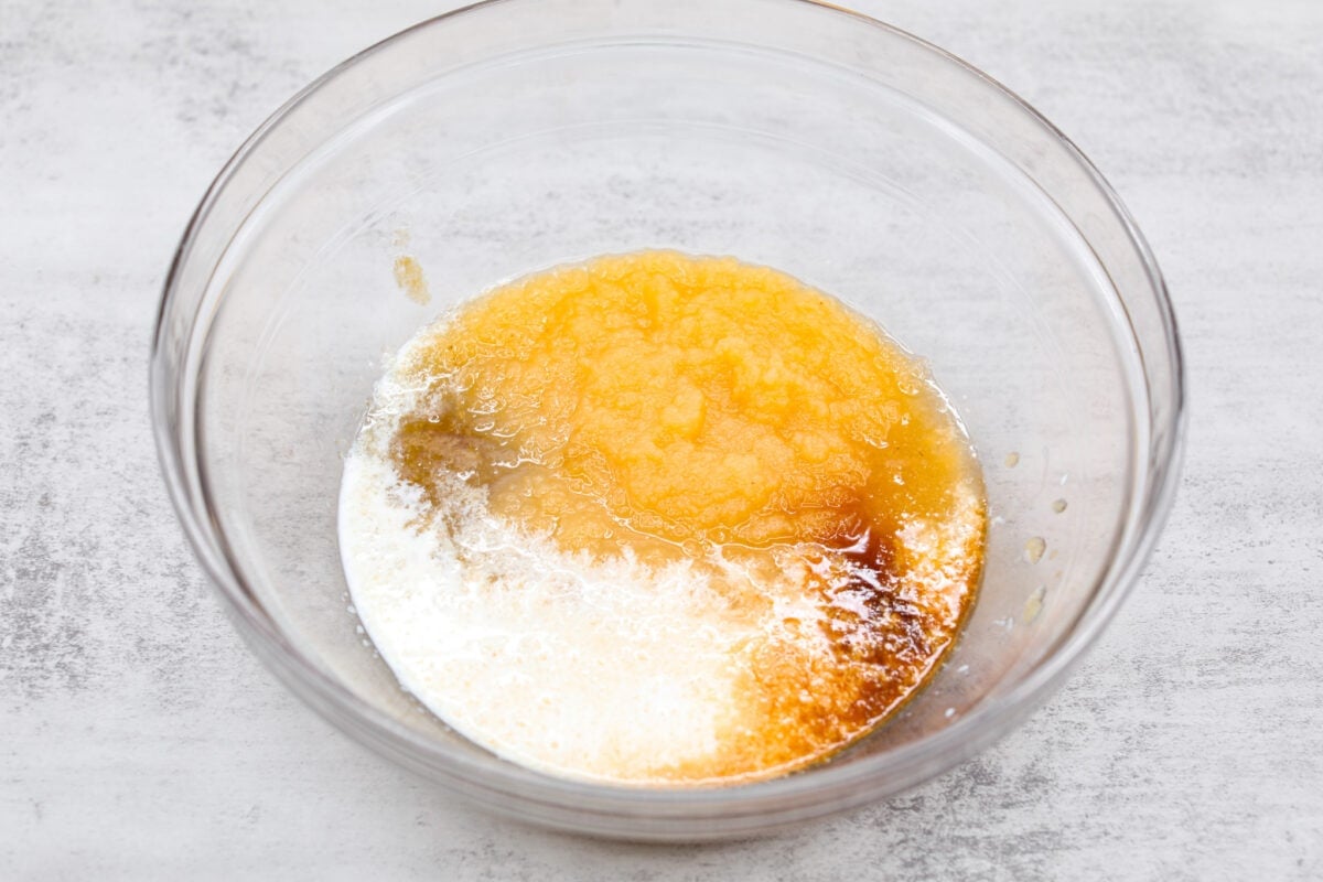 I see a batch of sweet and ultra-moist applesauce muffins in your future! Theyโre so delicious and made with all-natural sugars. The perfect breakfast, snack, dessert, you name it! The wet ingredients being combined.