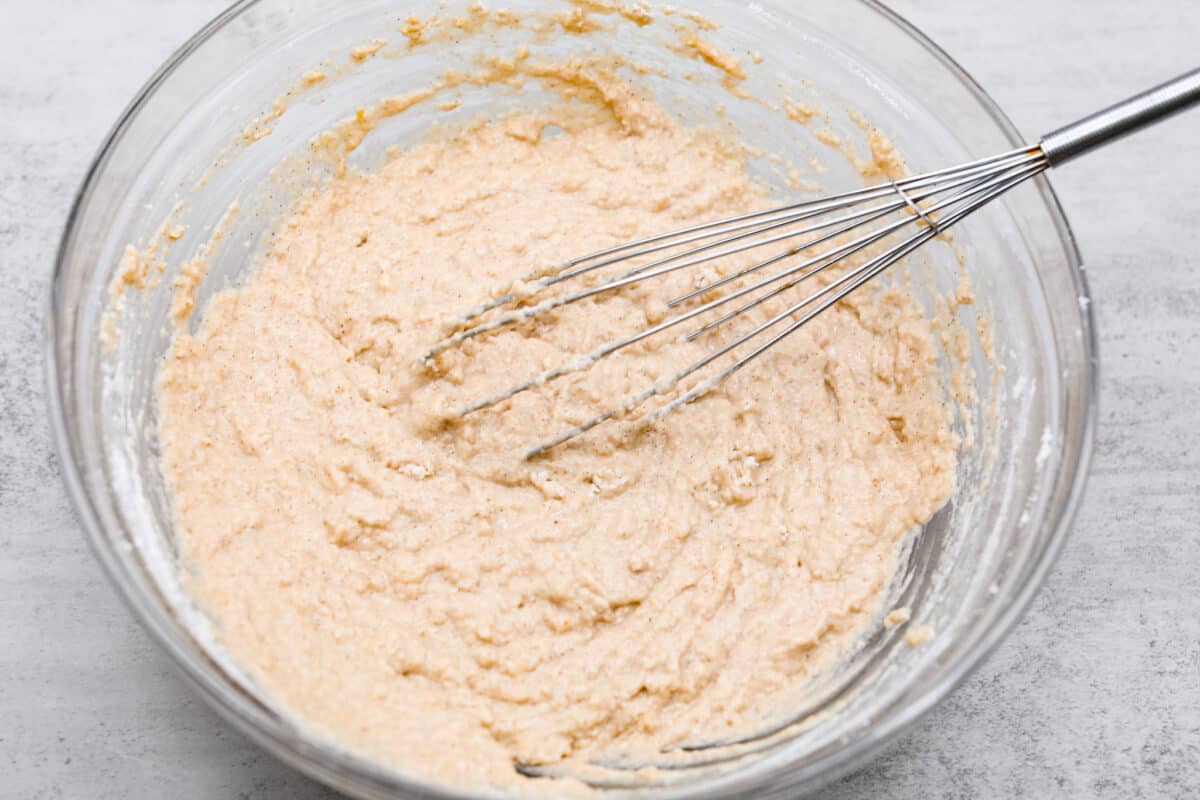 I see a batch of sweet and ultra-moist applesauce muffins in your future! Theyโre so delicious and made with all-natural sugars. The perfect breakfast, snack, dessert, you name it! Both the dry and wet ingredients being mixed together.