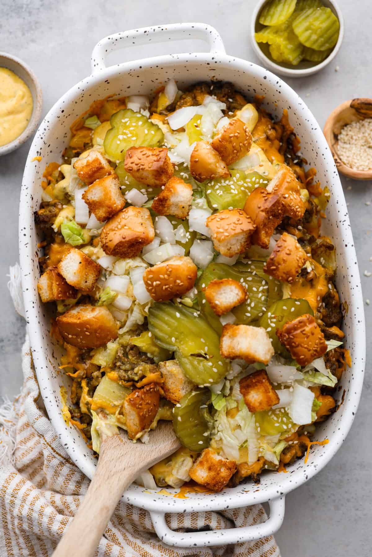 Meaty, cheesy, and chock full of tasty mix-ins like hash browns, pickles, and onions, Big Mac casserole is the perfect dinner to make this week! Itโs an easy, deconstructed version of the classic burger we all know and love. Top-down view of a Big Mac casserole topped with croutons.