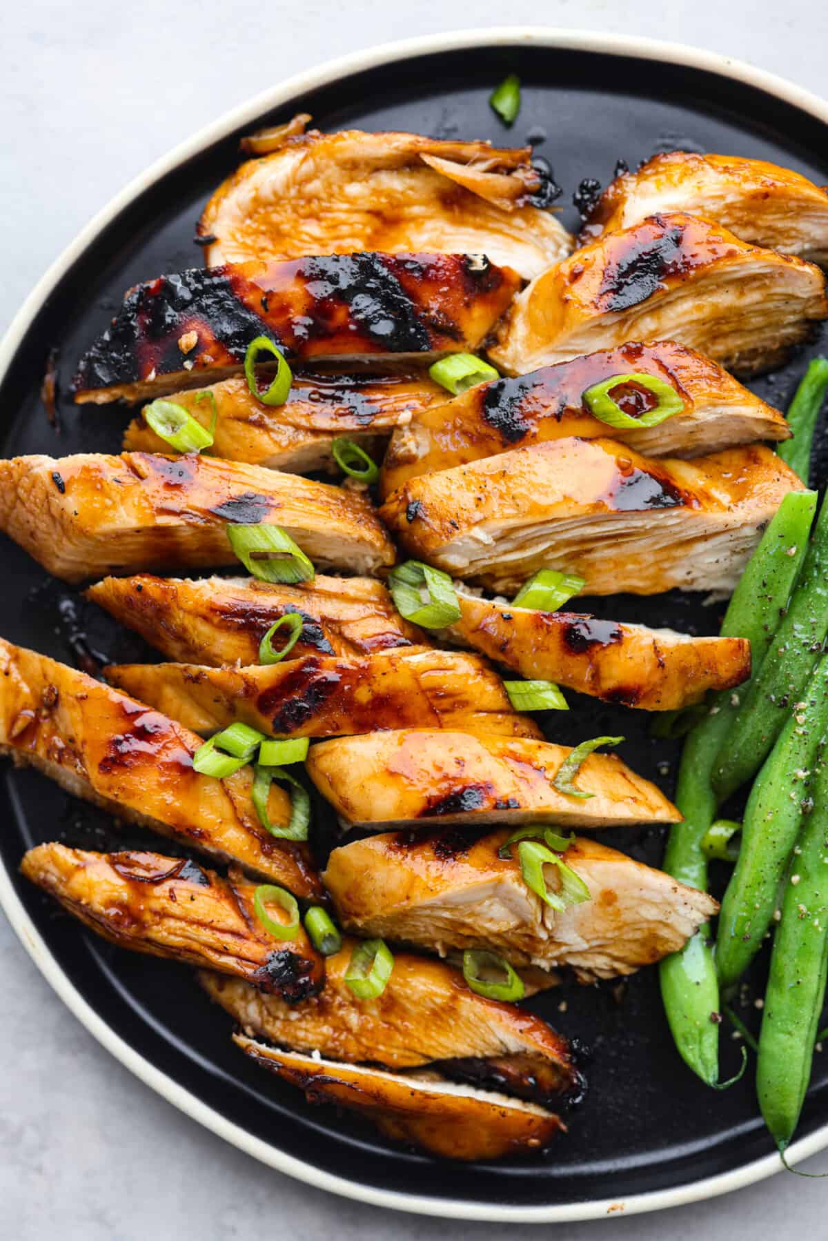 This delicious bourbon marinade will add wonderful depth of flavor and tenderize any meat you're cooking, from steak to chicken! This recipe uses ingredients like brown sugar, Worcestershire sauce, apple cider vinegar, garlic and bourbon to infuse each piece of meat with the perfect savory, sweet and tangy flavor. Grilled chicken, cut into strips, that has been marinated in the Bourbon marinade.
