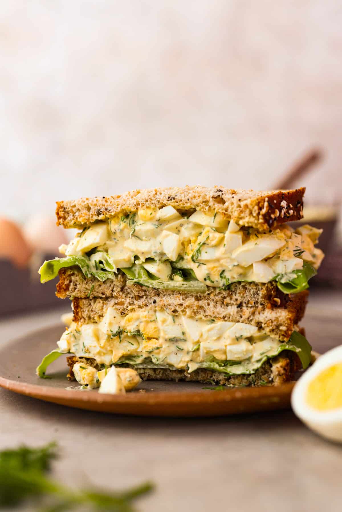 This amazing egg salad recipe is made with simple ingredients and is so creamy and delicious! So easy to put together and perfect for sandwiches. It will be your new potluck go-to. 2 slices of an egg salad sandwich.