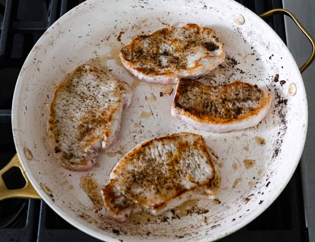 French Onion Pork Chops have all of the wonderful flavors of the classic soup in pork chop form! Caramelized onions and seared pork chops are joined with a savory sauce and two types of cheese for an amazing meal. Everything is cooked in one pan for a quick and easy weeknight dinner! Searing the pork chops