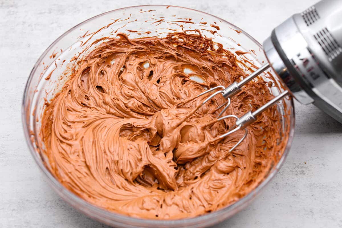 Celebrate St. Patrickโs Day (or any day) with this delicious Guinness Chocolate Cake! Itย has the most wonderful fudgy flavor and tender texture that is complemented by a Bailey's buttercream filling and a rich ganache frosting. Whipping up the frosting for the chocolate Guinness cake