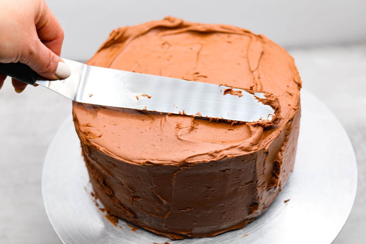 Celebrate St. Patrickโs Day (or any day) with this delicious Guinness Chocolate Cake! Itย has the most wonderful fudgy flavor and tender texture that is complemented by a Bailey's buttercream filling and a rich ganache frosting. Frosting the Guinness cake