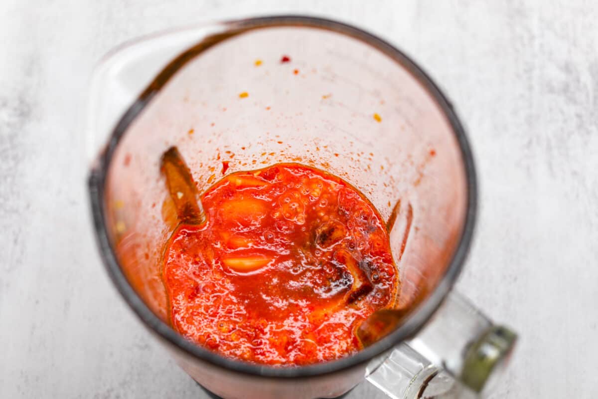 If hot sauce is something you use a lot in your kitchen, you have to try this homemade version! Tweak it to your liking then use it to upgrade all of your favorite dishes! The blended chiles in the bottom of a measuring cup.