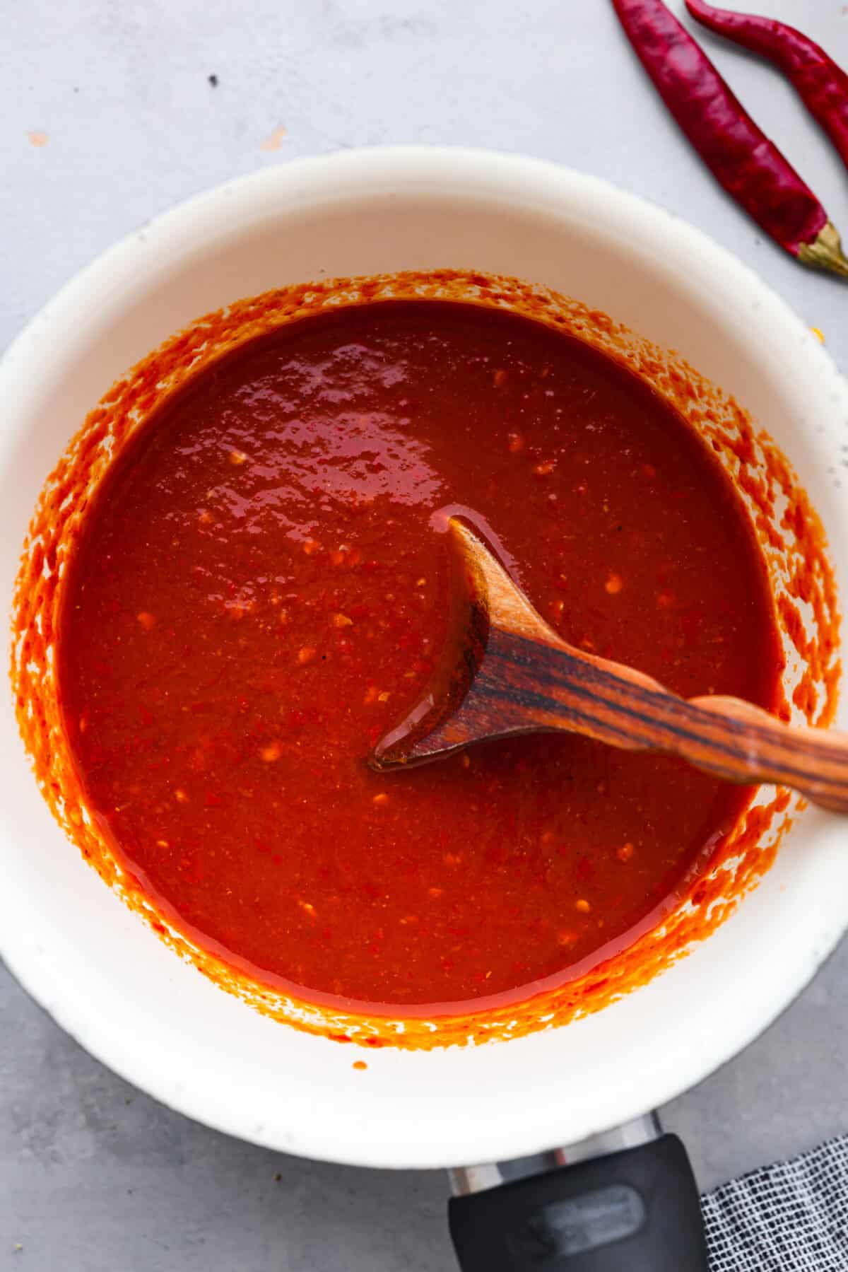 If hot sauce is something you use a lot in your kitchen, you have to try this homemade version! Tweak it to your liking then use it to upgrade all of your favorite dishes! Hot sauce in a white bowl.