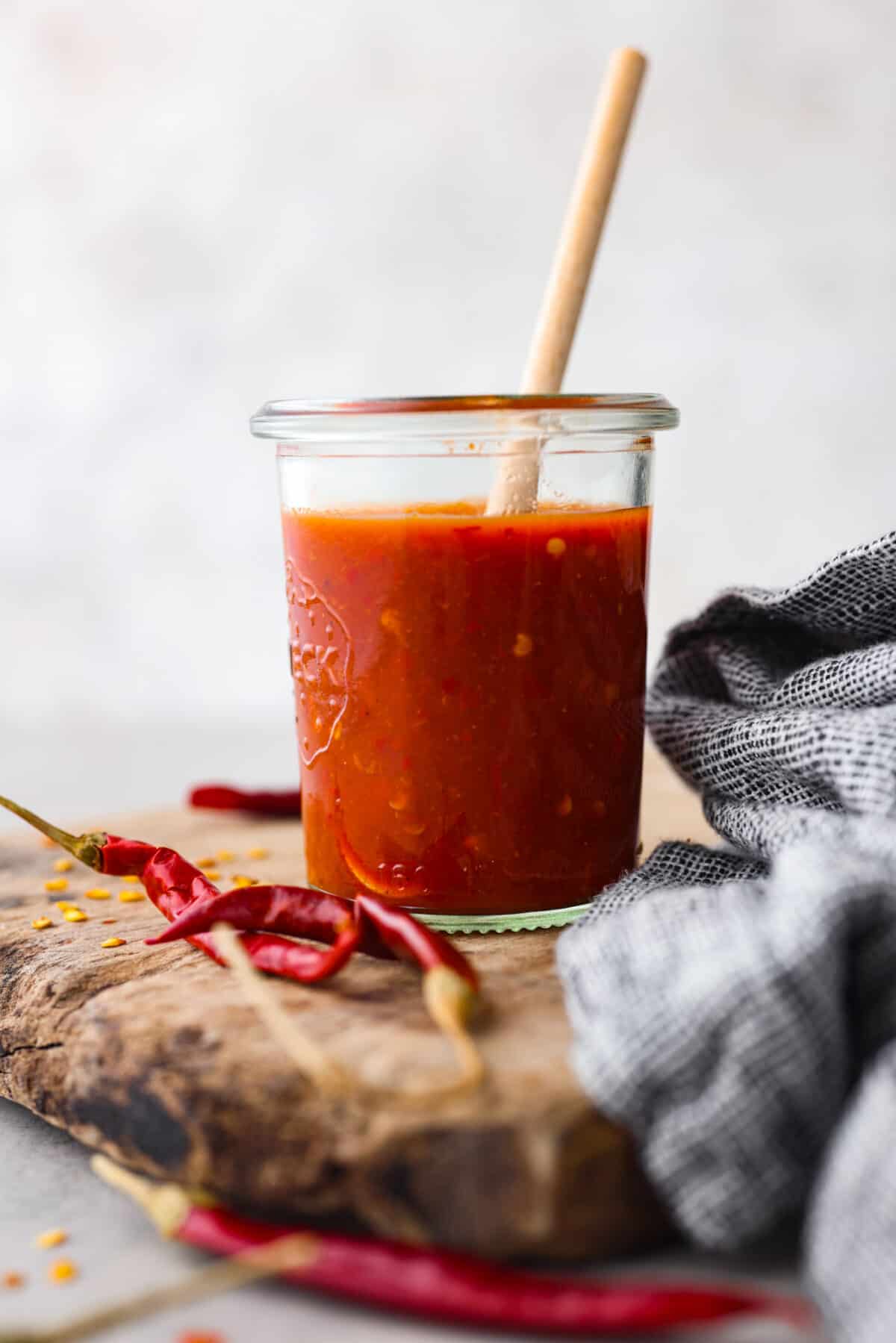 If hot sauce is something you use a lot in your kitchen, you have to try this homemade version! Tweak it to your liking then use it to upgrade all of your favorite dishes! Homemade hot sauce in a glass jar.