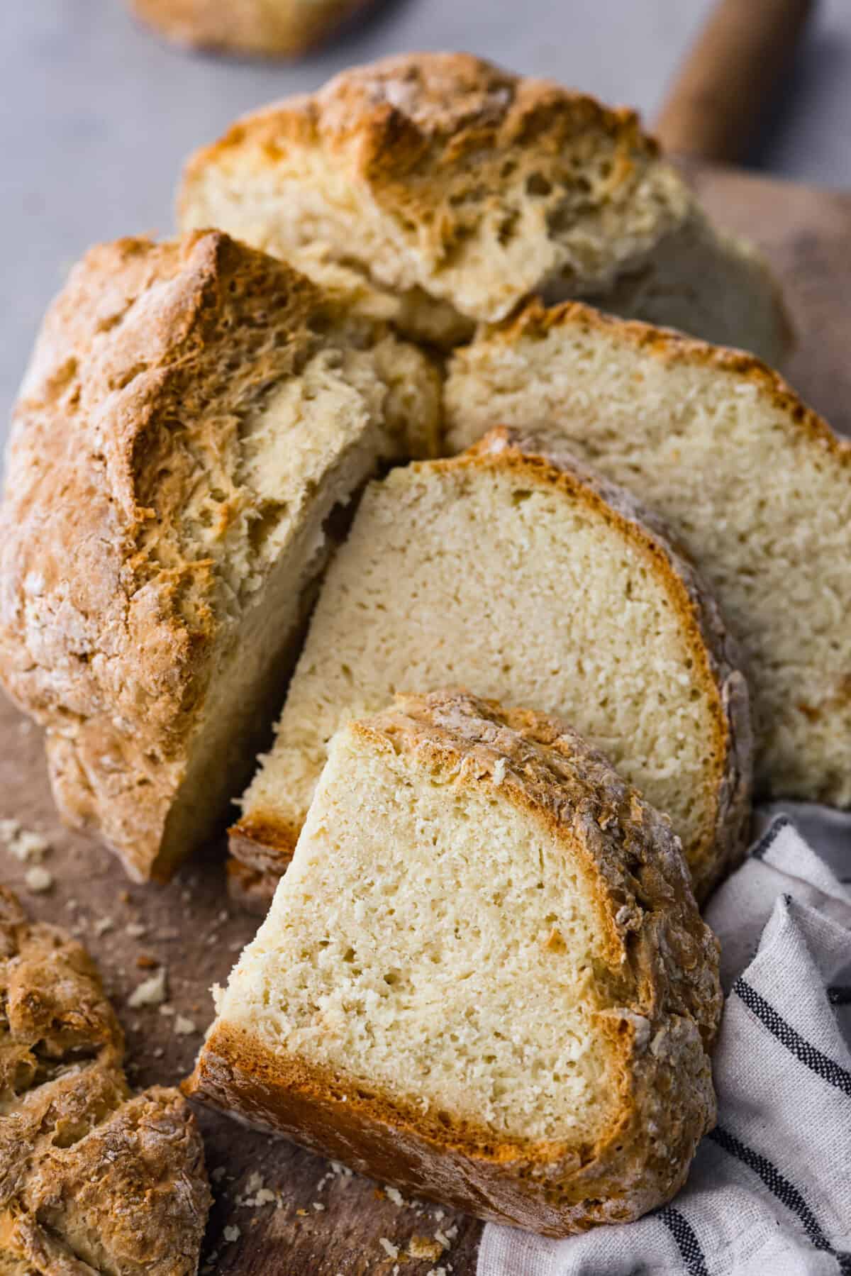 Baking soda vs baking powder....what is the difference? I'm here to teach you the basics of each so that you can improve your baking skills. Learn the whys, hows, and when they're important to achieving delicious recipes. Close view of soda bread cut onto a wood board.