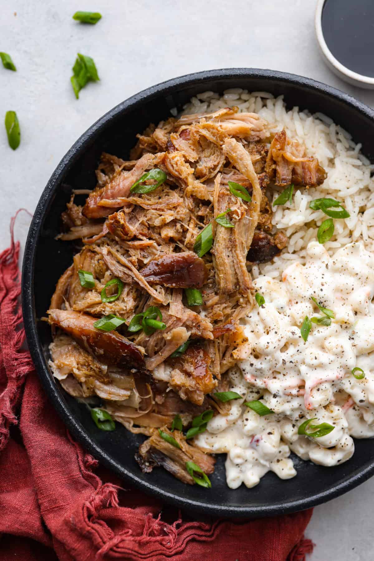 Tender slow cooker kalua pulled pork is salty, smokey melt-in-your-mouth perfection. Enjoy authentic Hawaiian luau pork flavor at home with this super simple 3 ingredient masterpiece.