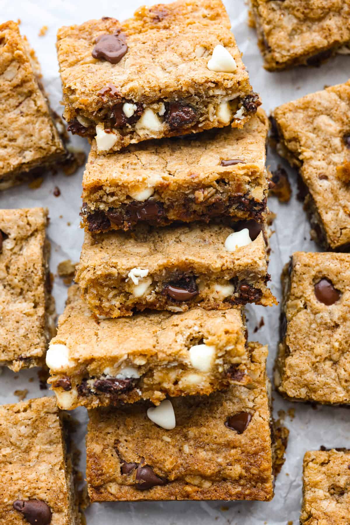 Win over everyoneโs heart (and stomach!) with these Marry Me Cookie Bars! They have the BEST flavor and texture, made with rolled oats, both white and semi-sweet chocolate chips, and a pinch of cinnamon! Chewy, creamy, chocolatey goodness! Top-down view of marry me cookie bars cut into squares.