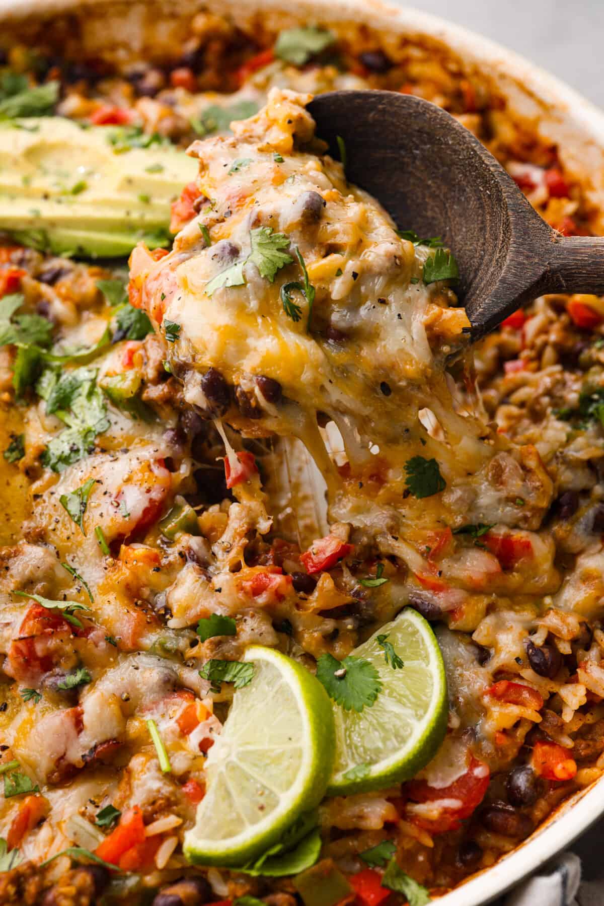 Okay, but can we talk about how gorgeous this taco skillet is?! Like, if dinner could be a showoff, this would be it. Itโs giving melty, cheesy, golden perfection, and the best part? It all comes together in one pan. Closeup of a spoonful of taco skillet.
