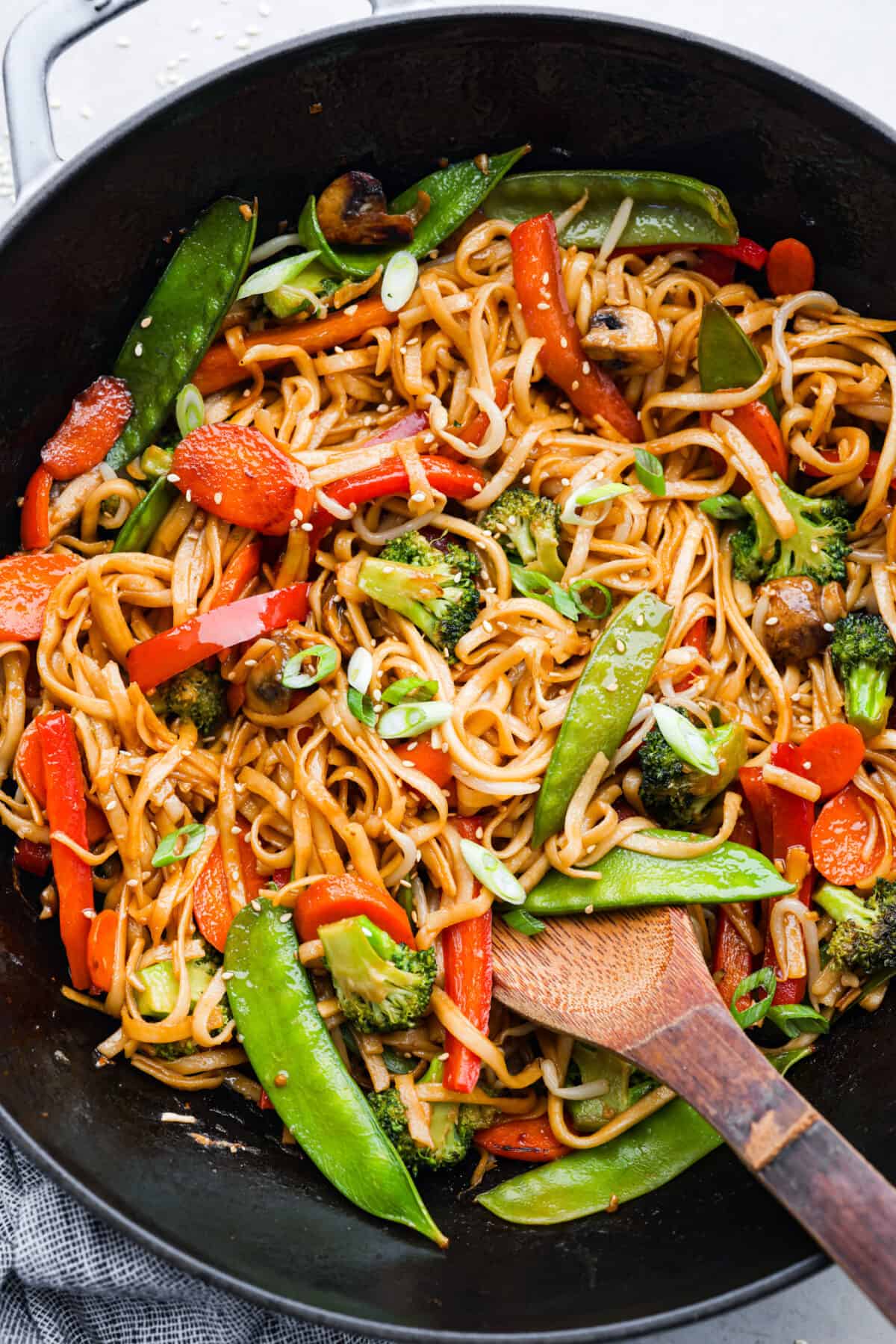 20-minute Vegetable Lo Mein is a super easy weeknight dish loaded with fresh, stir-fried veggies! Vegetable lo mein in a black frying pan.