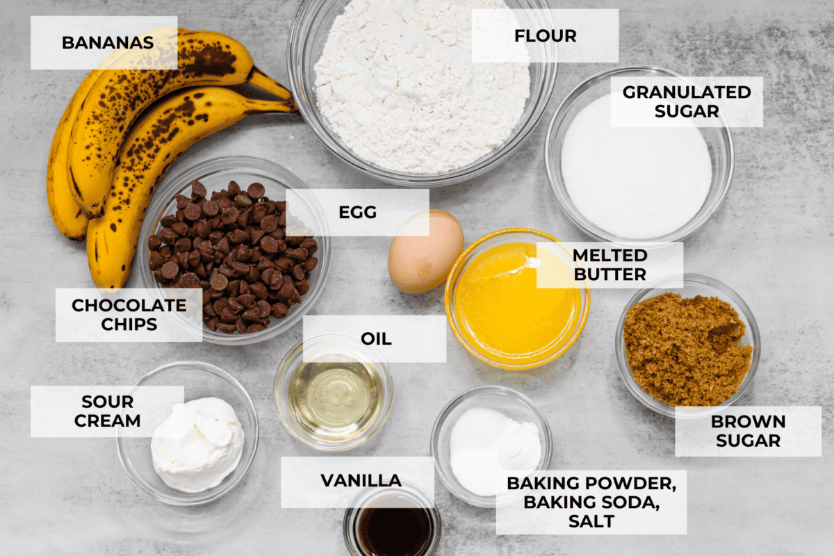 Treat yourself to these delicious Banana Chocolate Chip Muffins! With just a handful of ingredients and easy steps, you'll have moist and flavorful muffins ready to enjoy for breakfast (or to snack on!) in no time. A top shot of ingredients for the muffins, all in glass bowls and labeled.