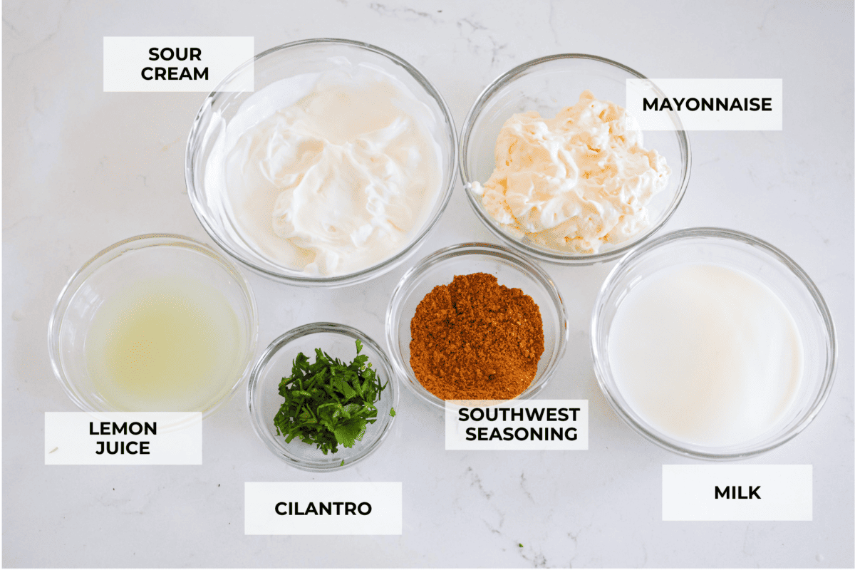 This creamy Southwest dressing is packed with zesty lime and bold spices, ready to upgrade your favorite bowl of greens! It takes less than 10 minutes and only a few pantry staples to make. All of the dressing ingredients, separated into small glass bowls.