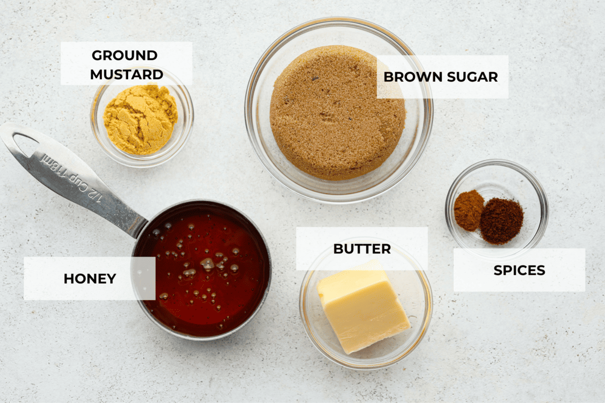 Elevate your Easter ham with this super easy homemade glaze! Made with simple spices, brown sugar, honey, and butter, itโs the best way to add extra flavor and texture. A must-make! All of the glaze ingredients separated into glass bowls.