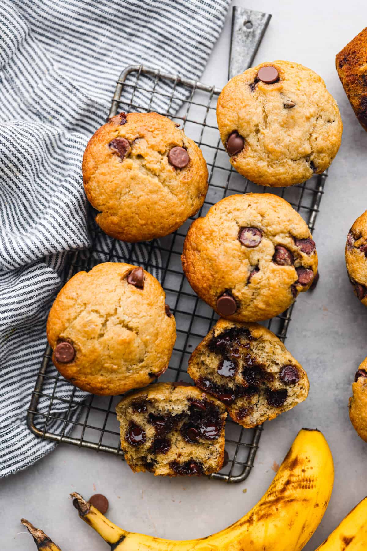 Treat yourself to these delicious Banana Chocolate Chip Muffins! With just a handful of ingredients and easy steps, you'll have moist and flavorful muffins ready to enjoy for breakfast (or to snack on!) in no time. Baked muffins on a cooling rack.