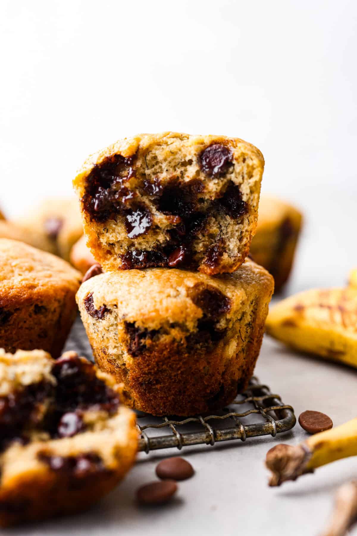 Treat yourself to these delicious Banana Chocolate Chip Muffins! With just a handful of ingredients and easy steps, you'll have moist and flavorful muffins ready to enjoy for breakfast (or to snack on!) in no time. A stack of 2 banana chocolate chip muffins.