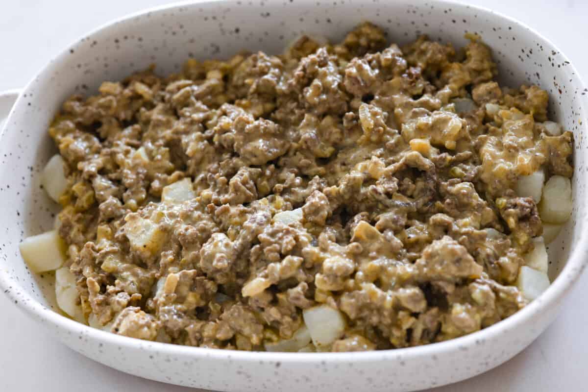 Meaty, cheesy, and chock full of tasty mix-ins like hash browns, pickles, and onions, Big Mac casserole is the perfect dinner to make this week! Itโs an easy, deconstructed version of the classic burger we all know and love. The meat layer being added.