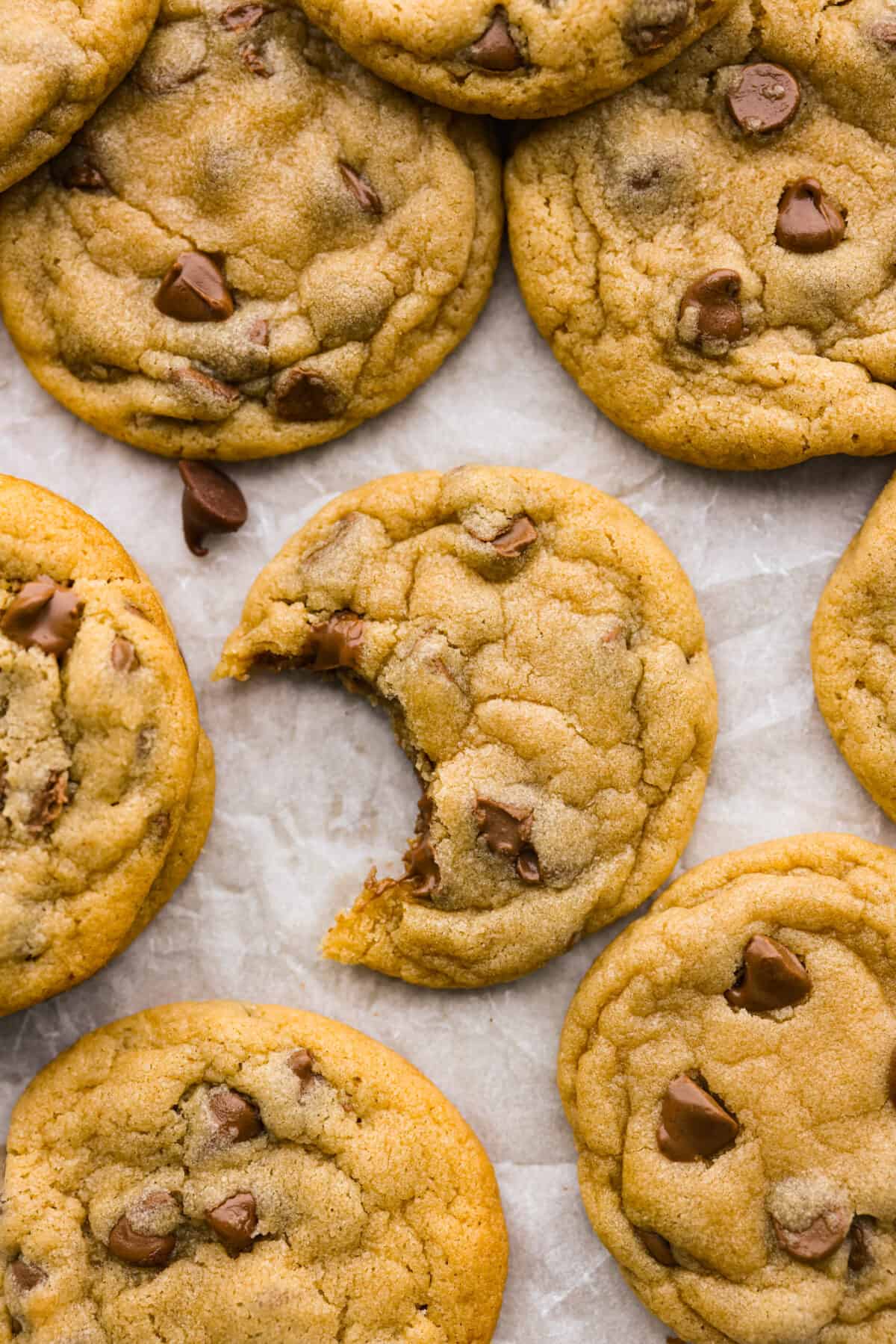 Introducing the softest and chewiest chocolate chip pudding cookies to ever come out of your oven! Adding Instant pudding mix creates the perfect cookie that dreams are made of. Top view of chocolate chip pudding cookies with a bite out of one of them.