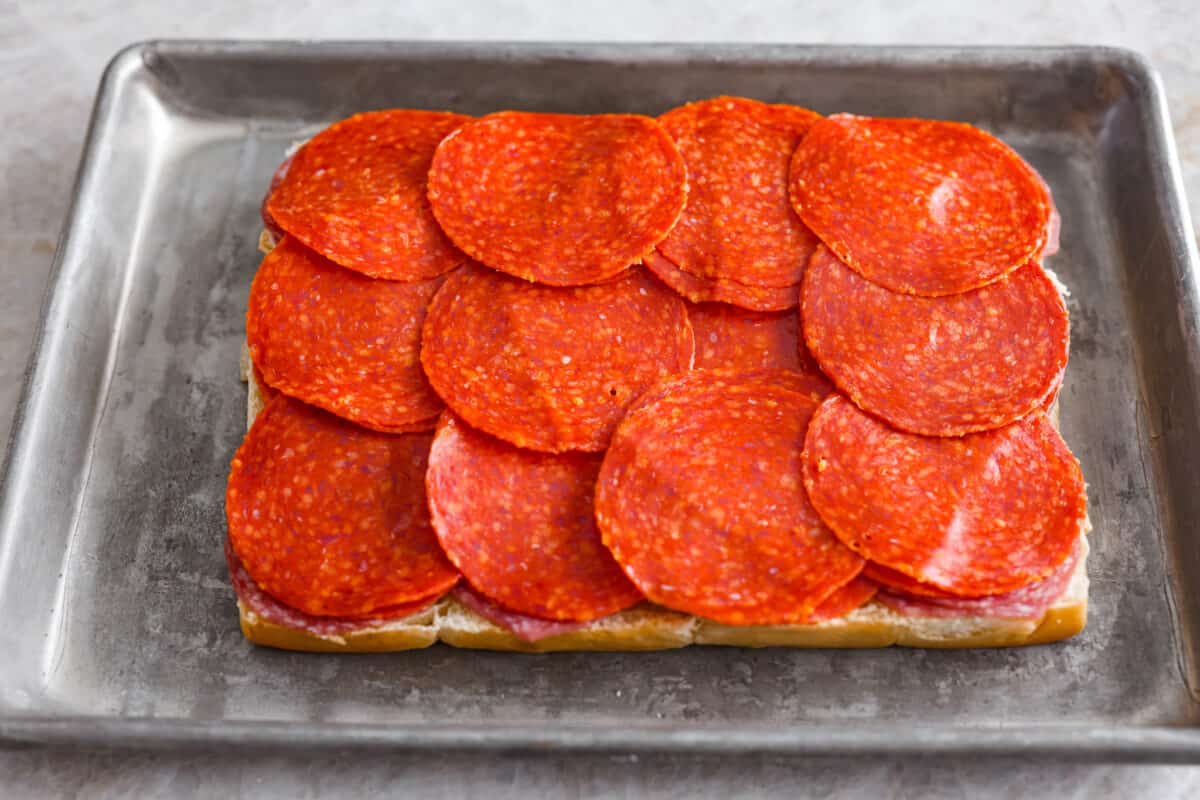 The classic grinder sandwich made into sliders to share! You've got Hawaiian rolls topped with layers of pepperoni, salami, turkey, provolone, and creamy grinder salad. And to top things off- each roll is brushed with a buttery parmesan glaze and baked to golden brown perfection. Adding the pepperoni layer