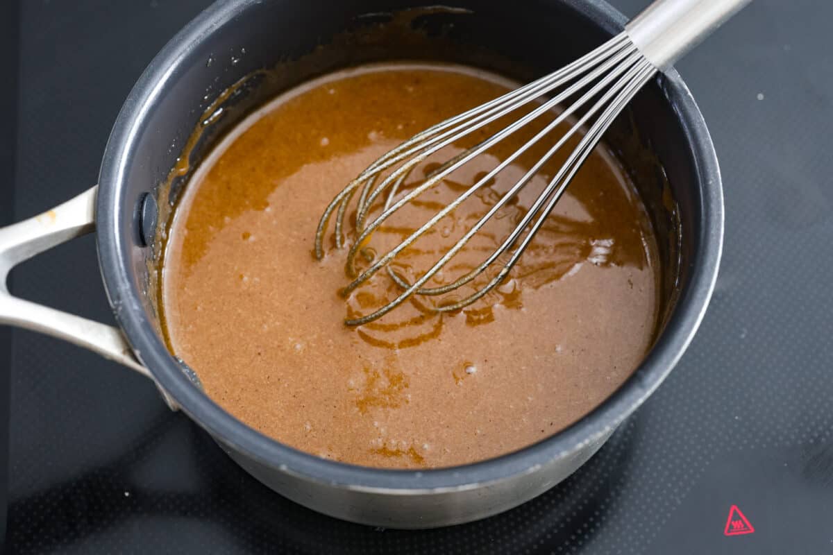 Elevate your Easter ham with this super easy homemade glaze! Made with simple spices, brown sugar, honey, and butter, itโs the best way to add extra flavor and texture. A must-make! The ham glaze ingredients being whisked together.