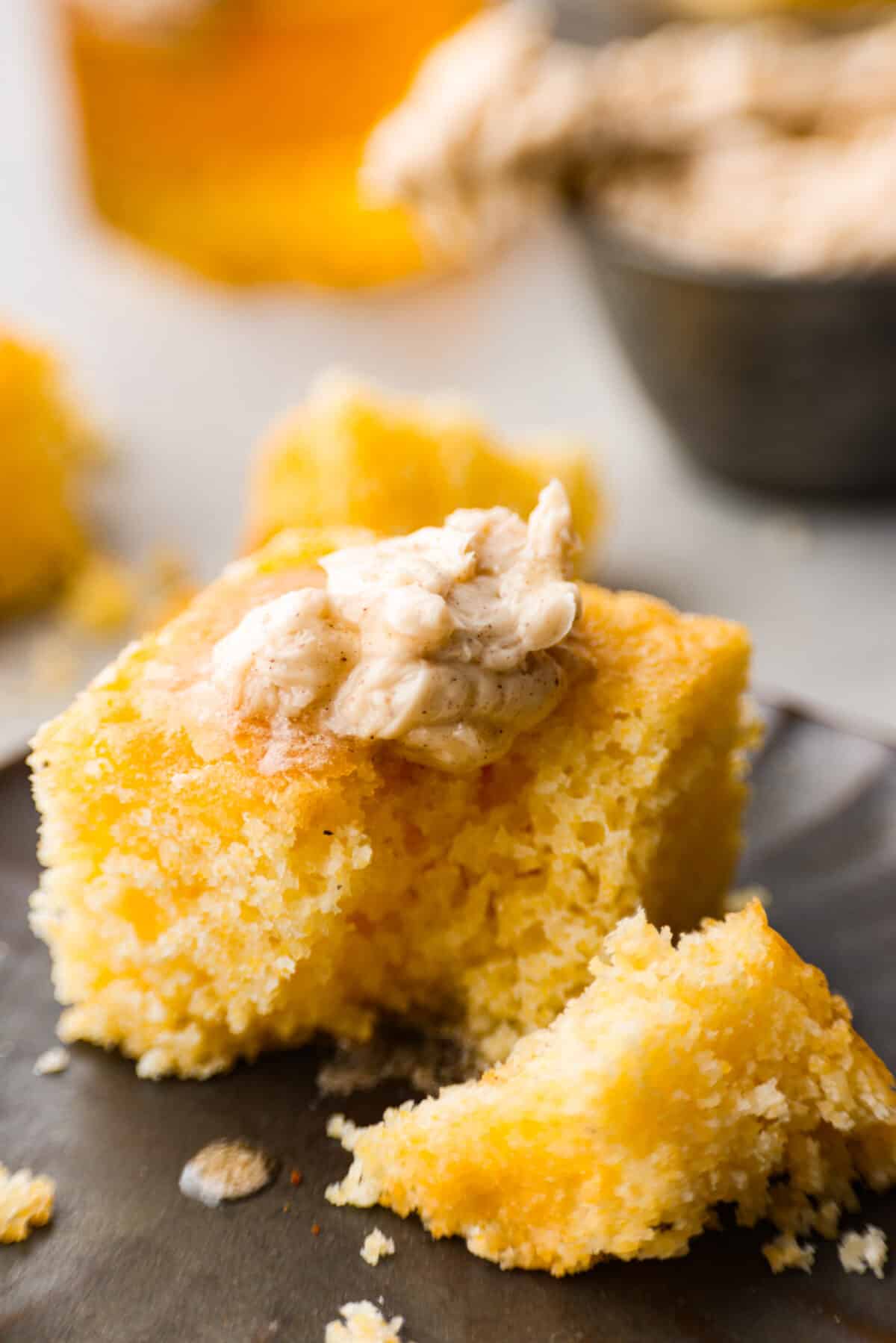 This honey butter recipe is so easy to make, and perfect on everything from rolls and toast to muffins. One taste and you’ll be hooked! A square of cornbread topped with a dollop of the sweet spread.