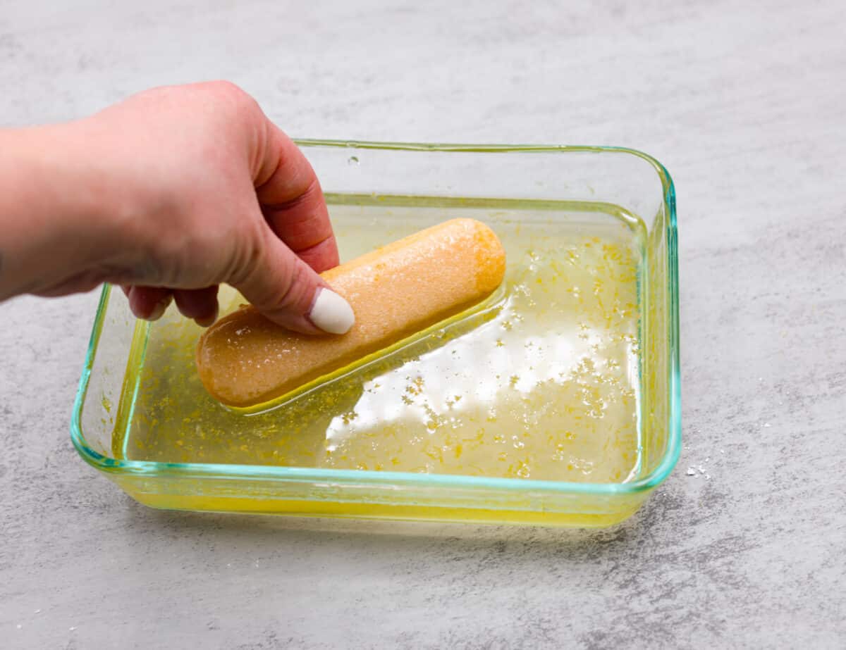 Meet lemon tiramisu! The most amazing citrusy twist on a classic Italian dessert. The layers of mascarpone cream and lemon curd will have you reaching for another slice! Soaking the ladyfingers in lemon syrup to act as the base of the lemon tiramisu.