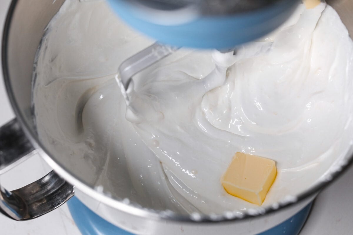 The most delicious Swiss Meringue Buttercream is easy to make with just 5 simple ingredients! It whips up deliciously light and silky with the right amount of sweetness. The perfect finishing touch for all of your favorite treats! Adding butter to the Swiss meringue