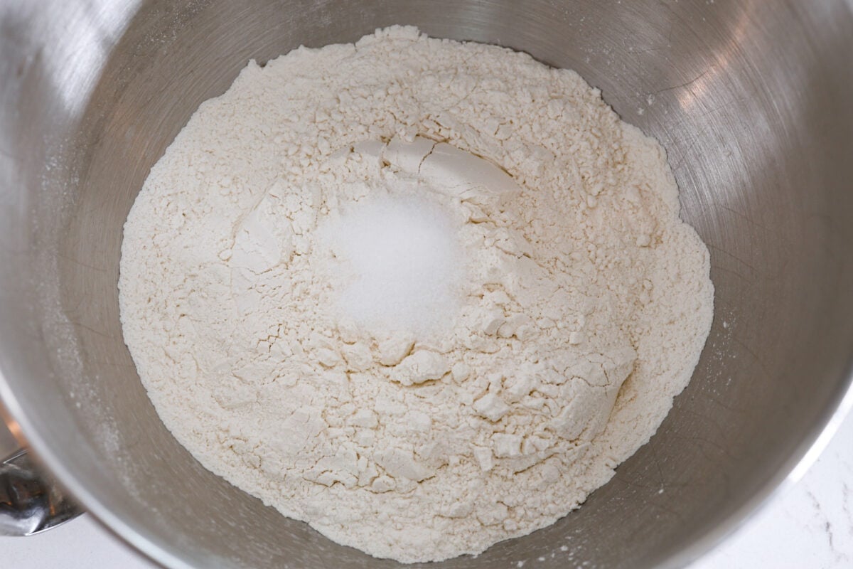 Perfectly soft buttery rolls will be your classic go-to roll recipe! They are tender fluffy, and baked with a buttery golden top. These rolls are sure to be a family favorite! Second process shot of the flour and salt combined in a bowl.
