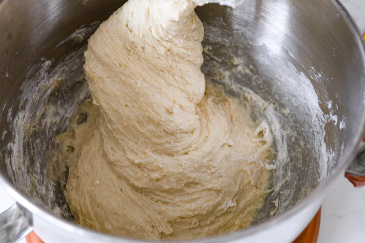 Perfectly soft buttery rolls will be your classic go-to roll recipe! They are tender fluffy, and baked with a buttery golden top. These rolls are sure to be a family favorite! Fourth process photo of the dough mixed together.