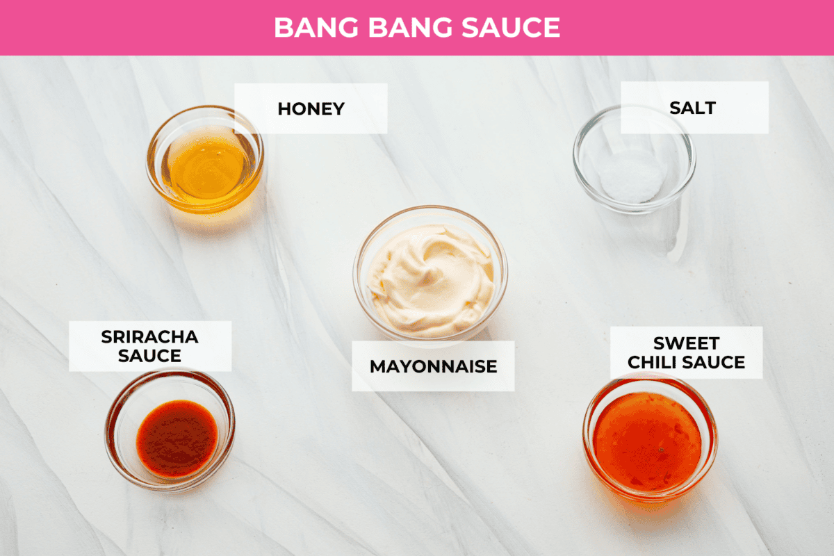 These Bang Bang Shrimp Tacos are made with deliciously crunchy shrimp cooked to perfection and coated in a special sauce that's just bursting with flavor! It's a meal that's sure to impress. Ingredients on the counter in separate bowls to make bang bang sauce.