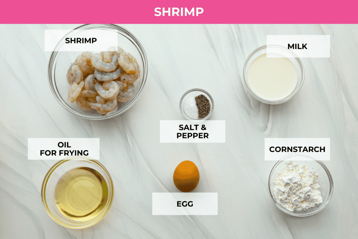 These Bang Bang Shrimp Tacos are made with deliciously crunchy shrimp cooked to perfection and coated in a special sauce that's just bursting with flavor! It's a meal that's sure to impress. Shrimp ingredients for bang bang shrimp tacos laid out on a counter and labeled.