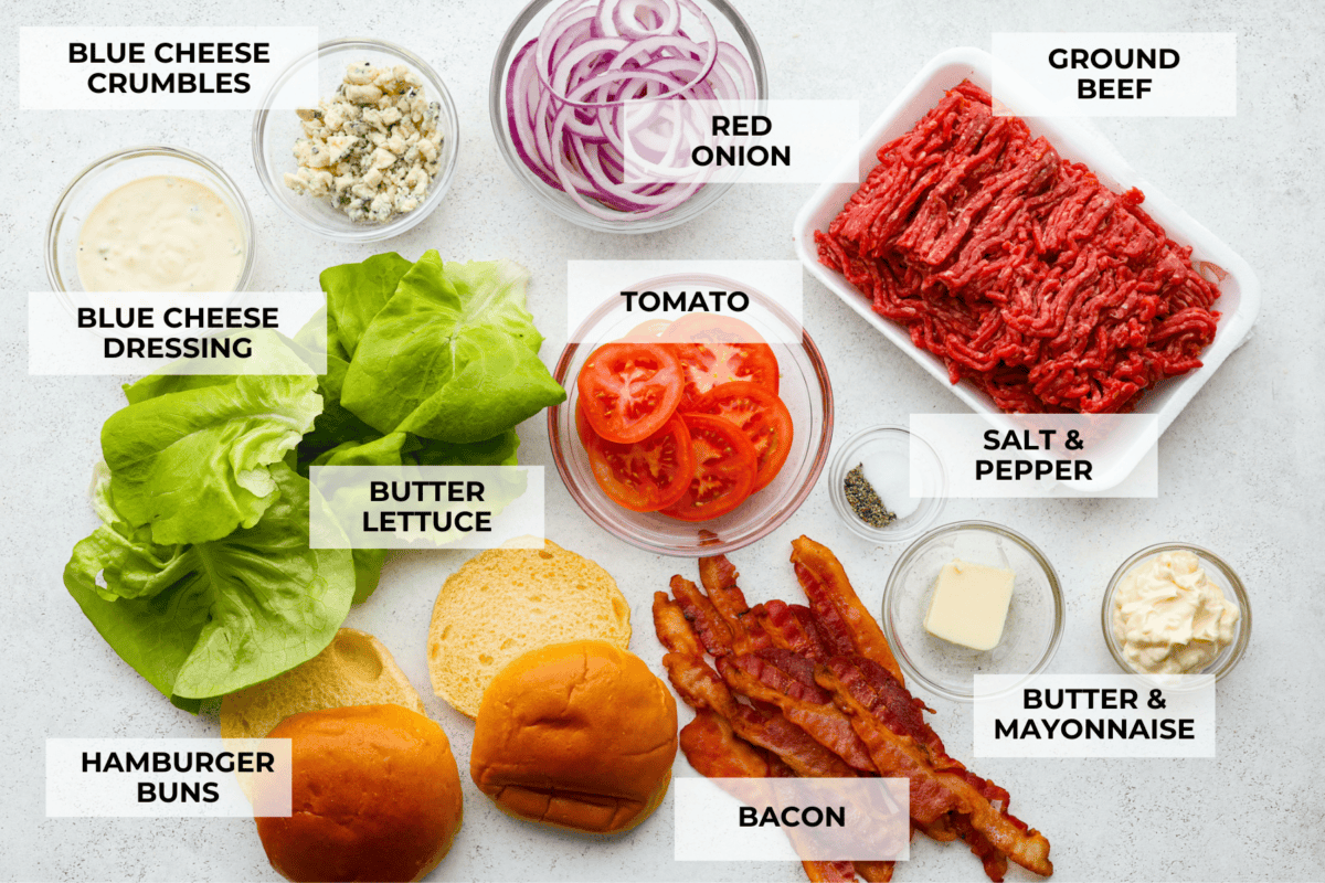 Get ready to be blown away by this Blue Cheese Burger! It's thick, juicy, and filled with flavor. If you love blue cheese dressing, this recipe is for you! That unique tangy flavor is the perfect addition to the juiciest patty ever. Overhead view of ingredients with labels.