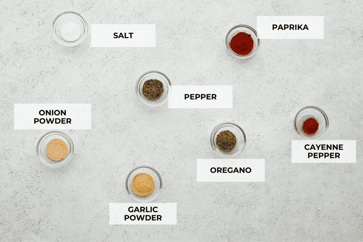 This flavorful Burger Seasoning will take your favorite burger recipe to a new level of delicious! It’s a simple, yet tasty blend of staple spices and seasonings that makes each bite better than the next! Top view of each ingredient in a small glass bowl and labeled.