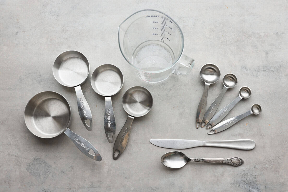 Whether you are a seasoned baker or just starting out, this informational post has all of my tips and tricks on how to properly measure baking ingredients. Measuring cups and spoons laid out on the counter.