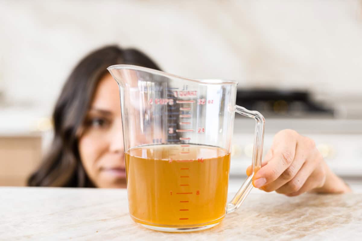 Whether you are a seasoned baker or just starting out, this informational post has all of my tips and tricks on how to properly measure baking ingredients. Liquid being measured properly at eye level showing the importance of how to measure baking ingredients properly.