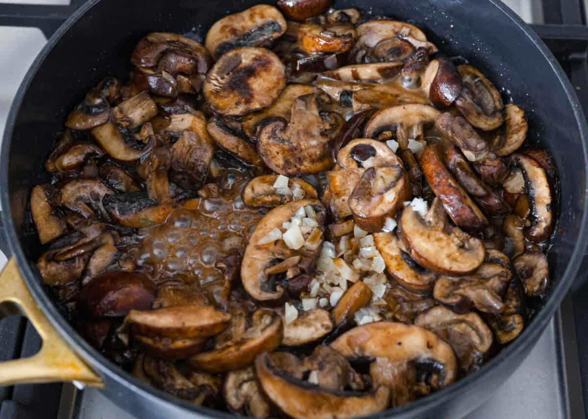 Create the most flavorful, juicy Mushroom Swiss Burger! Perfectly seasoned ground beef is topped with sautรฉed buttery mushrooms and melty Swiss cheese then loaded on fluffy buns for a gourmet burger that's easy to make at home! Mushrooms cooked on skillet.