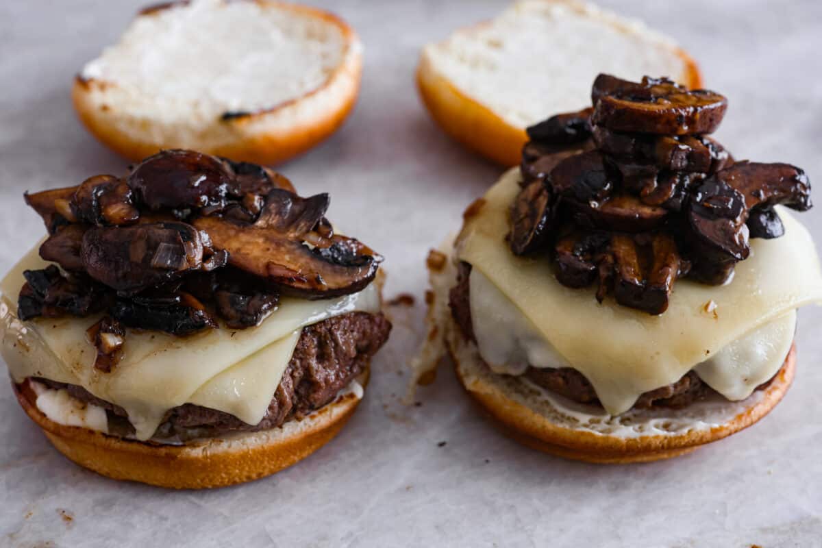 Create the most flavorful, juicy Mushroom Swiss Burger! Perfectly seasoned ground beef is topped with sautรฉed buttery mushrooms and melty Swiss cheese then loaded on fluffy buns for a gourmet burger that's easy to make at home! Top the burger with the mushroom mixture.