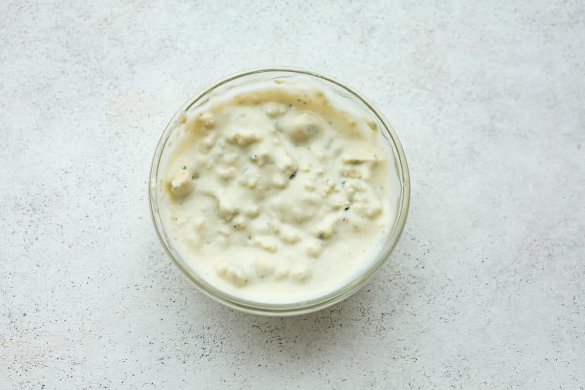 Get ready to be blown away by this Blue Cheese Burger! It's thick, juicy, and filled with flavor. If you love blue cheese dressing, this recipe is for you! That unique tangy flavor is the perfect addition to the juiciest patty ever. Overhead view of blue cheese dressing in a bowl.