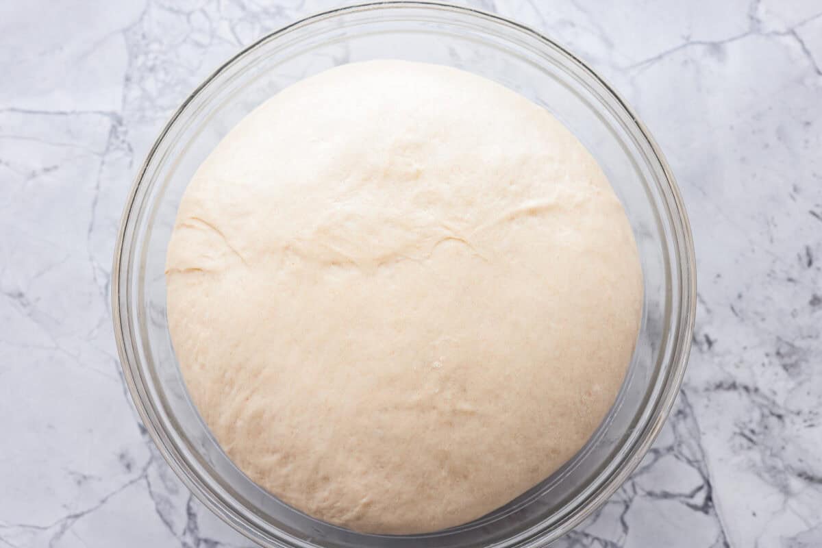 You asked for help with yeast, so I have created a "How to Bake with Yeast" guide just for you! Yeast doesn't have to be intimidating, and I hope that by the end of this post, you will be an expert! A picture of properly proofed dough in a clear glass bowl showing how to bake with yeast.