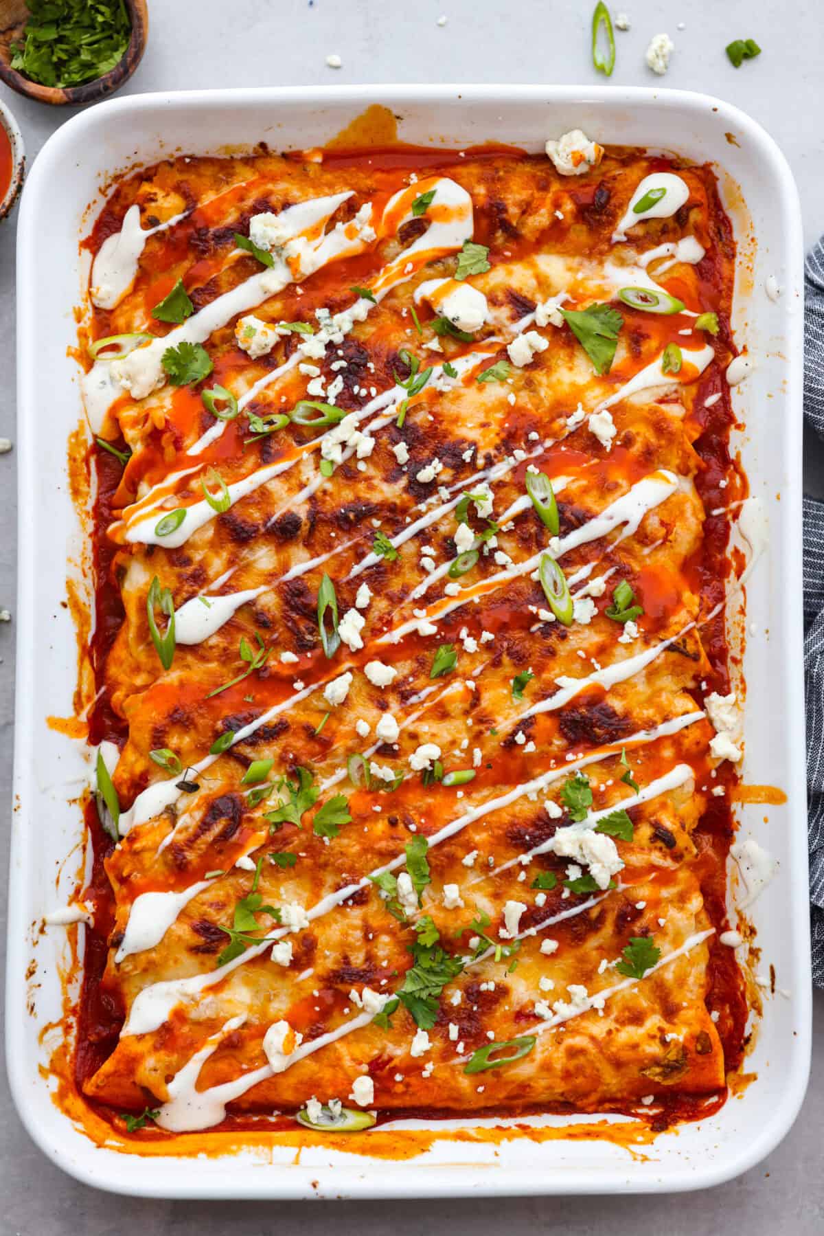 A new enchilada is in town! Get ready for the bold flavors in these buffalo chicken enchiladas! Chicken enchiladas loaded with cheese and smothered in a creamy buffalo enchilada sauce.
